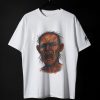 Tricou alb cu un portret abstract al unui bărbat care țipă, realizat în culori intense, fotografiat pe fundal negru.